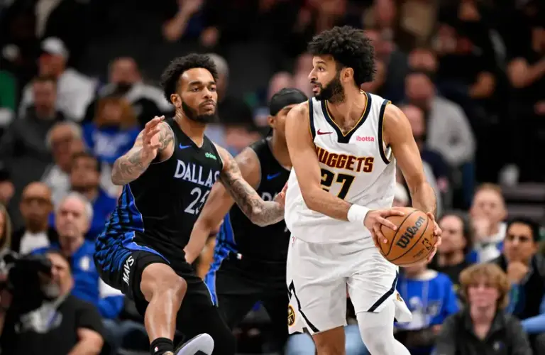Denver Nuggets guard Jamal Murray (27) handles the ball against Dallas Mavericks forward P.J. Washington (25) in the second half.