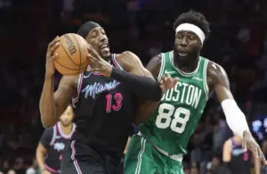 Boston Celtics center Neemias Queta (88) defends against Miami Heat center Bam Adebayo (13) during the first half at Kaseya Center