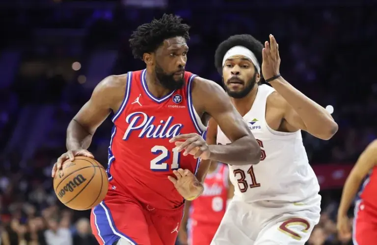 Philadelphia 76ers center Joel Embiid (21) dribbles past Cleveland Cavaliers center Jarrett Allen (31) during the second quarter at Xfinity Mobile Arena.