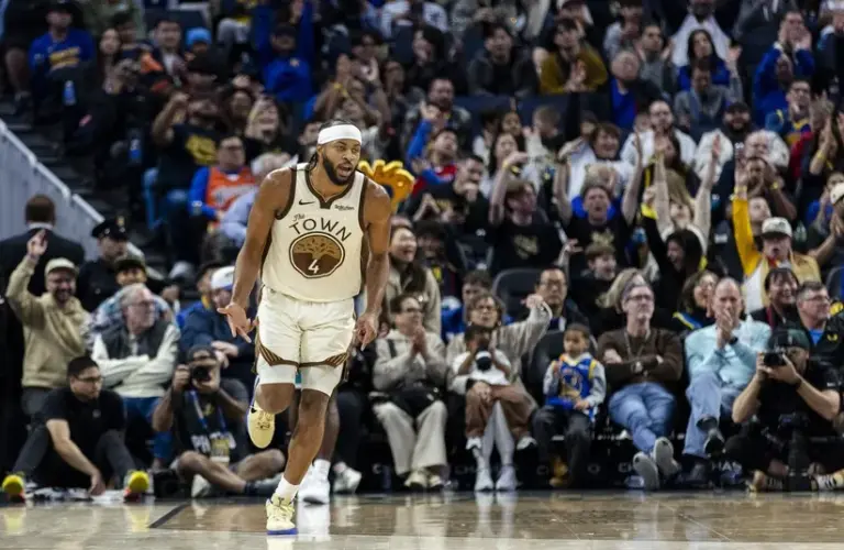 Golden State Warriors guard Moses Moody (4) reacts after hitting a three-point shot against the Charlotte Hornets during the fourth quarter at Chase Center.