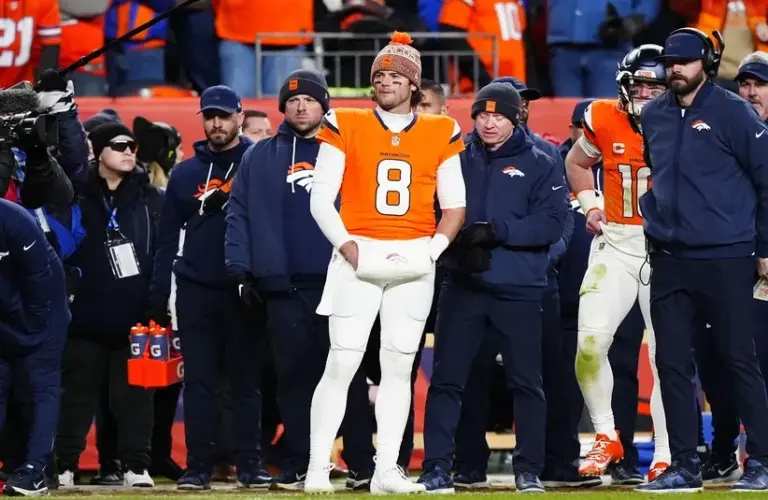 Denver Broncos quarterback Jarrett Stidham (8) stands next to quarterback Bo Nix (10)) during overtime of an AFC Divisional Round playoff game against the Buffalo Bills.