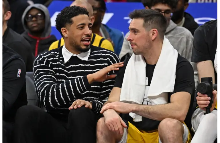 Pacers' Tyrese Haliburton talking to TJ McConnell on the bench in Philadelphia vs the Sixers