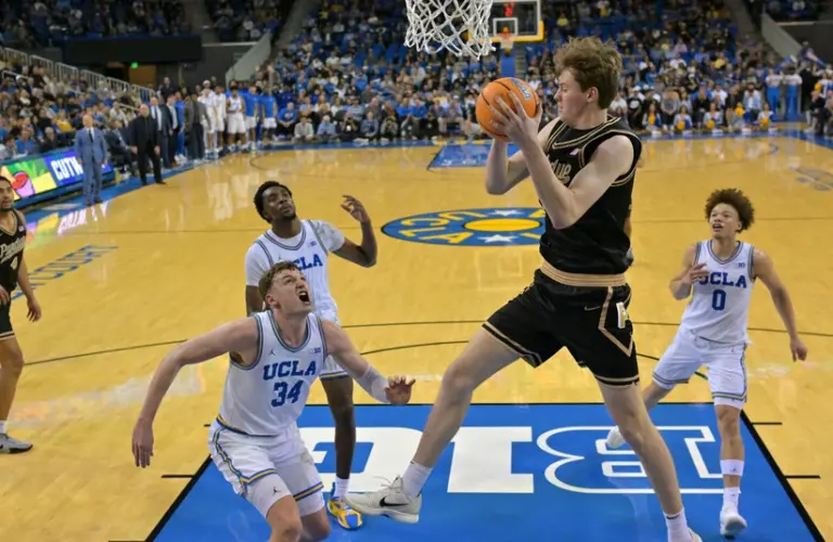Purdue player grabs a rebound.