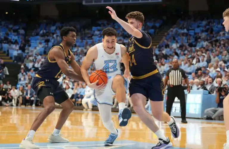 North Carolina Tar Heels guard Luka Bogavac (44) with the ball as Notre Dame Fighting Irish guard Sir Mohammed (13) and forward Matthew MacLellan (34) defend in the second half