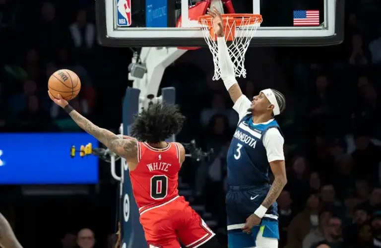 Minnesota Timberwolves forward Jaden McDaniels (3) jumps to block as Chicago Bulls guard Coby White (0) drives to the basket