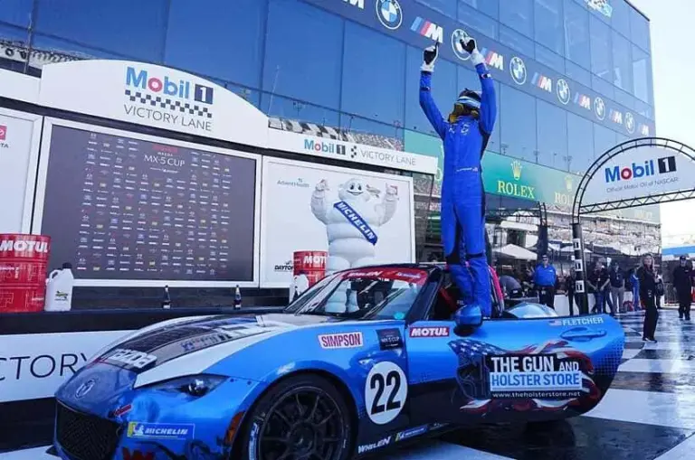 Jeremy Fletcher celebrates atop his No. 22 car in Victory Lane after winning the second Mazda MX-5 Cup race of Rolex 24 week, Friday, Jan. 23, 2026 at Daytona International Speedway.