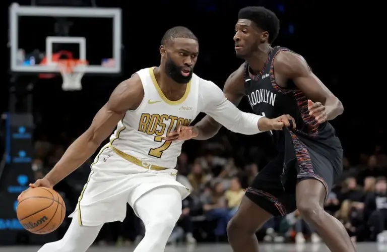 Boston Celtics guard Jaylen Brown (7) drives to the basket against Brooklyn Nets guard Drake Powell (4)