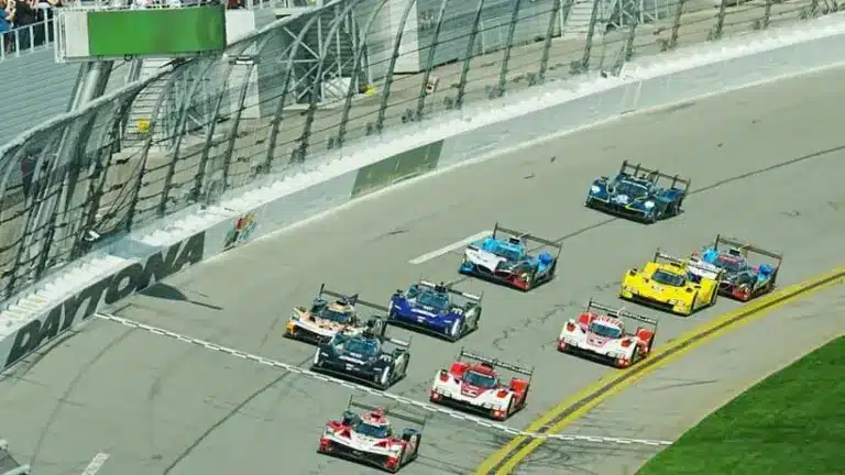 Cars cross the starting line to commence the 64th running of the Rolex 24, Saturday, Jan. 24, 2026 at Daytona International Speedway.