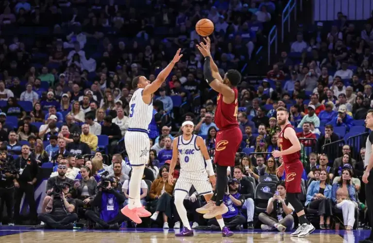 Cleveland Cavaliers guard Donovan Mitchell (45) shoots against Orlando Magic guard Desmond Bane (3) during the first quarter.