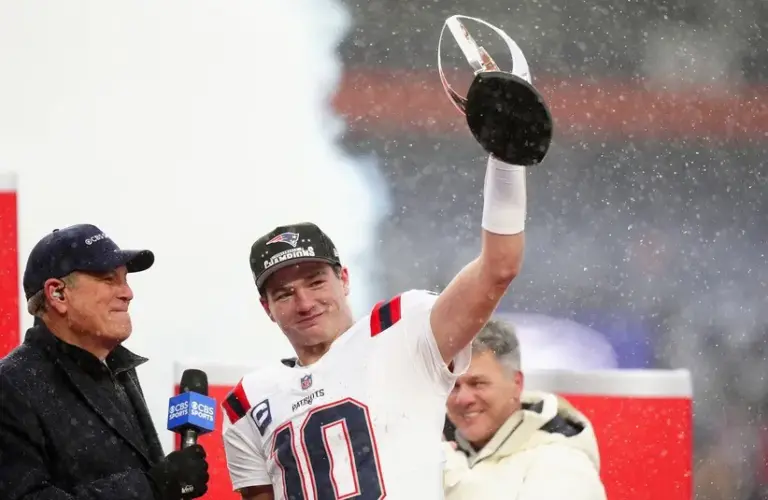 New England Patriots quarterback Drake Maye (10) holds the AFC Championship trophy while speaking to the media after defeating the Denver Broncos in the 2026 AFC Championship Game