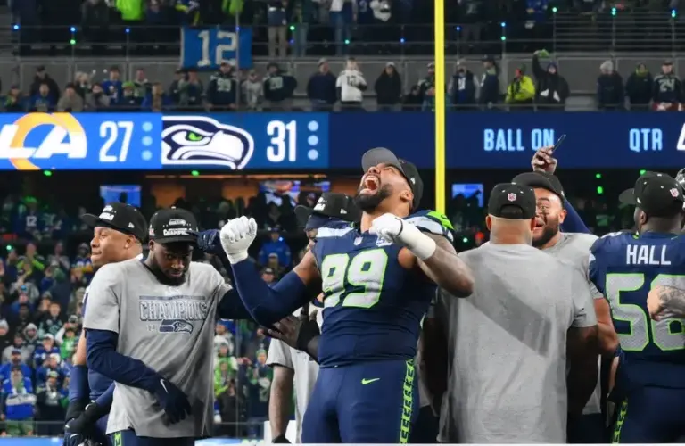 Seattle Seahawks defensive end Leonard Williams (99) celebrates on the podium after defeating the Los Angeles Rams in the 2026 NFC Championship Game at Lumen Field.