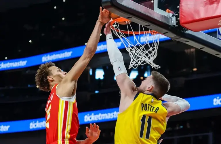 Atlanta Hawks guard Dyson Daniels (5) dunks the ball against Indiana Pacers center Micah Potter (11) during the first quarter at State Farm Arena.