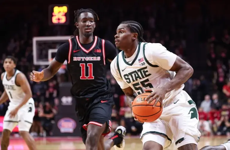 Michigan State Spartans forward Coen Carr (55) goes to the basket against Rutgers Scarlet Knights forward Christopher Nwuli (11) during the first half at Jersey Mike's Arena