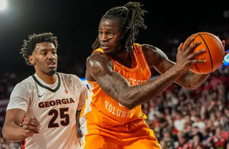 Tennessee Volunteers center Felix Okpara (34) controls the ball behind Georgia Bulldogs forward Justin Abson (25) during the first half.