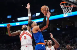 New York Knicks forward Josh Hart (3) goes up to make a basket against Toronto Raptors forward Brandon Ingram (3) during the first half.