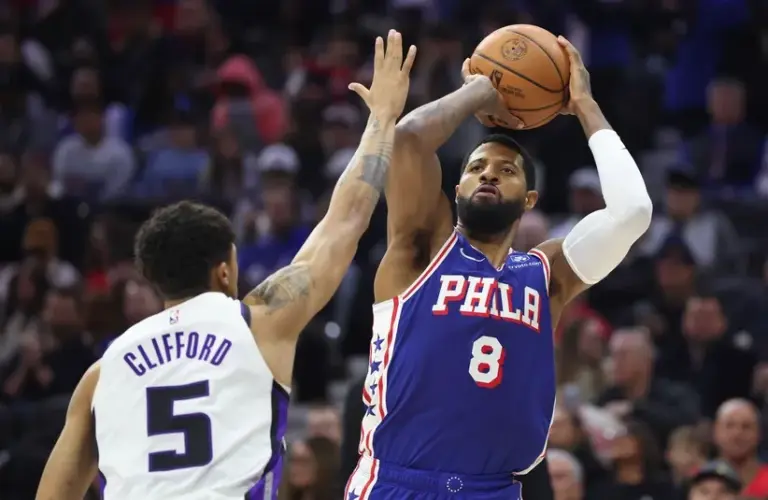 Philadelphia 76ers forward Paul George (8) shoots in front of Sacramento Kings guard Nique Clifford (5) during the third quarter at Xfinity Mobile Arena