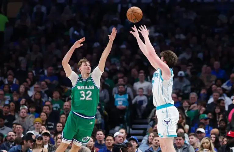 Jan 29, 2026; Dallas, Texas, USA; Charlotte Hornets guard Kon Knueppel (7) shoots over Dallas Mavericks forward Cooper Flagg (32) during the second half at American Airlines Center.
