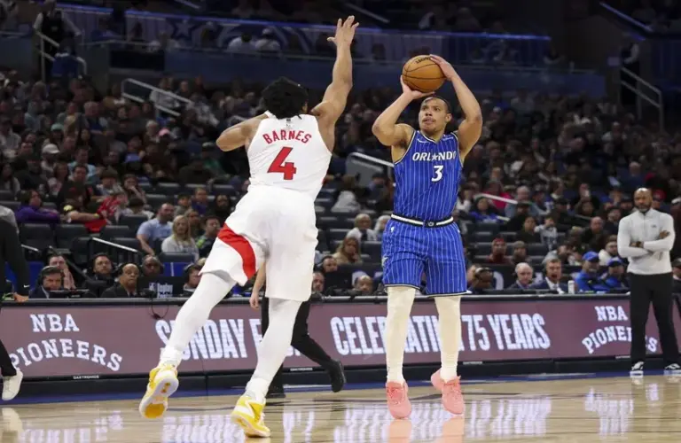 Orlando Magic guard Desmond Bane (3) shoots the ball over Toronto Raptors forward Scottie Barnes (4) in the second quarter at Kia Center