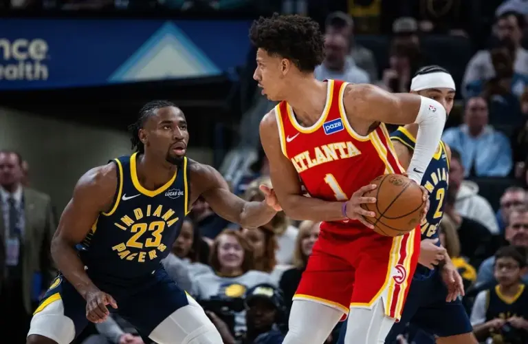 Atlanta Hawks forward Jalen Johnson (1) holds the ball while Indiana Pacers guard/forward Aaron Nesmith (23) defends.