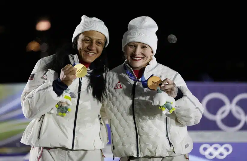 Feb 16, 2026; Cortina d'Ampezzo, Italy; Elana Meyers Taylor of the United States and Kaillie Armbruster Humphries of the United States celebrate on the podium after the women's bobsleigh monobob competition during the Milano Cortina 2026 Olympic Winter Games at Cortina Sliding Centre