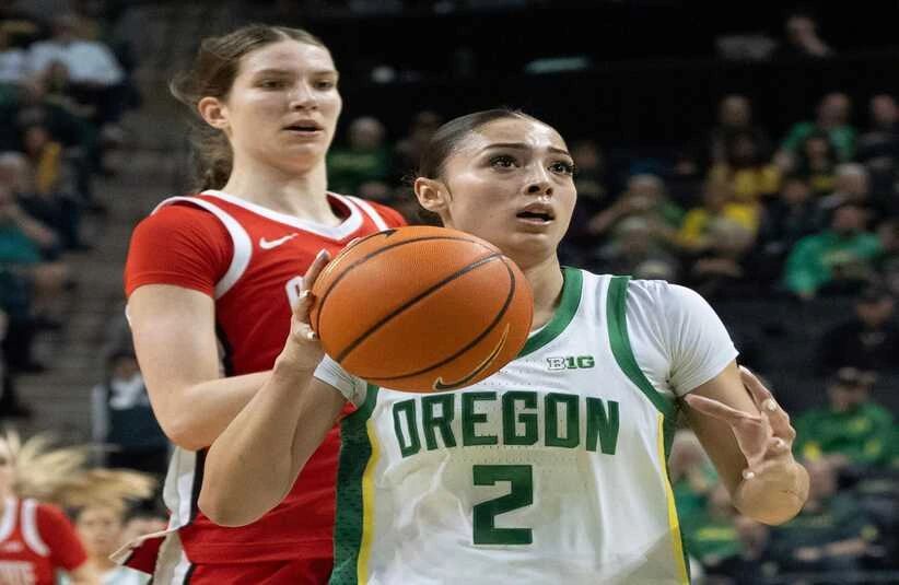 Oregon’s Katie Fiso, right, brings the ball down court ahead of Ohio State’s Elsa Lemmilä during the first half at Matthew Knight Arena in Eugene Feb. 8, 2026.