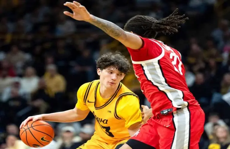 Iowa guard Isaia Howard (23) dribbles the basketball against Ohio State forward Devin Royal (21) Feb. 25, 2026 at Carver-Hawkeye Arena in Iowa City, Iowa.