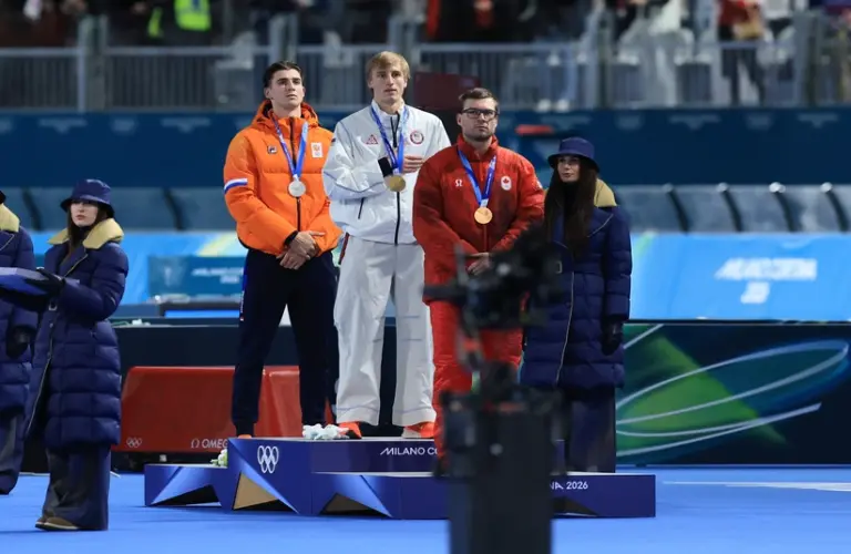 February 14, 2026; Milan, Italy; From left Jenning de Boo of the Netherlands, Jordan Stolz of the United States and Laurent Dubreuil of Canada on the podium after the men's speed skating 500m during the Milano Cortina 2026 Olympic Winter Games at Milano Speed Skating Stadium.