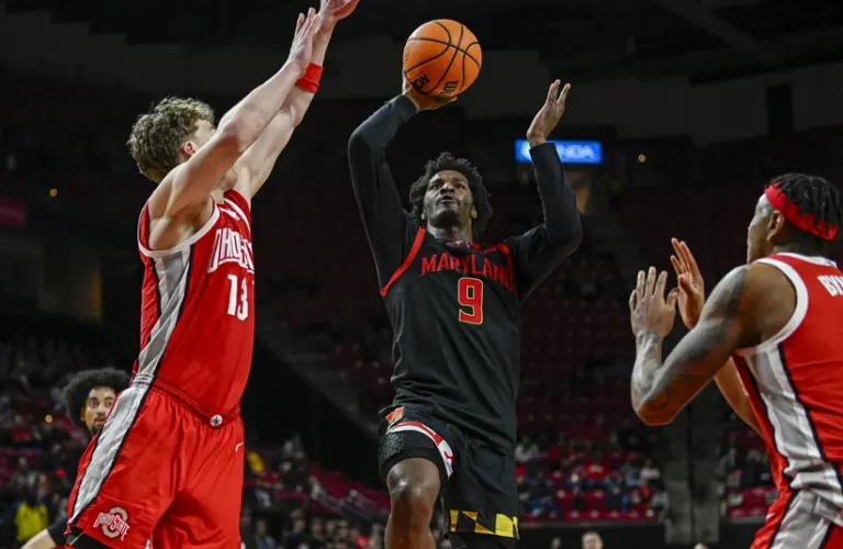 Feb 5, 2026; College Park, Maryland, USA; Maryland Terrapins forward Solomon Washington (9) shoots as Ohio State Buckeyes center Christoph Tilly (13) and forward Amare Bynum (1) defends during the second half at Xfinity Center.