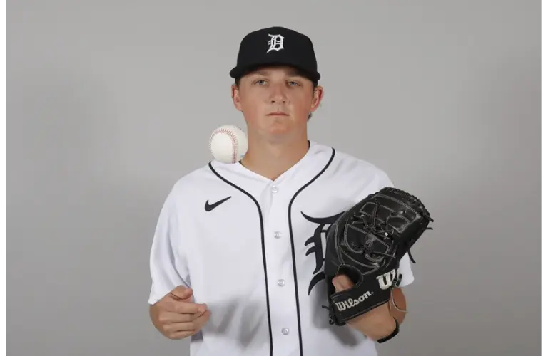 Reese Olson taking a picture with a Baseball