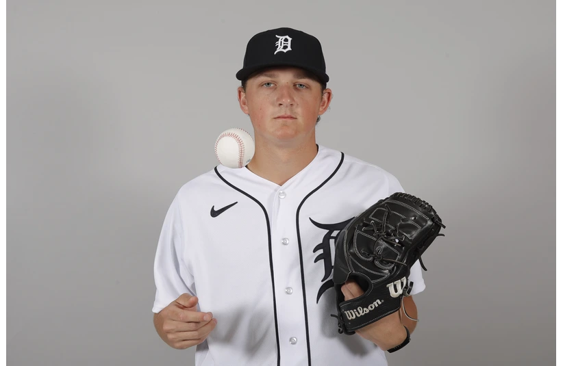 Reese Olson taking a picture with a Baseball