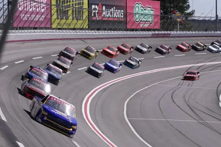 Feb 24, 2024; Hampton, Georgia, USA; NASCAR Craftsman Truck Series Driver Christian Eckes (19) leads the pack into turn four during the Fr8 208 at Atlanta Motor Speedway.