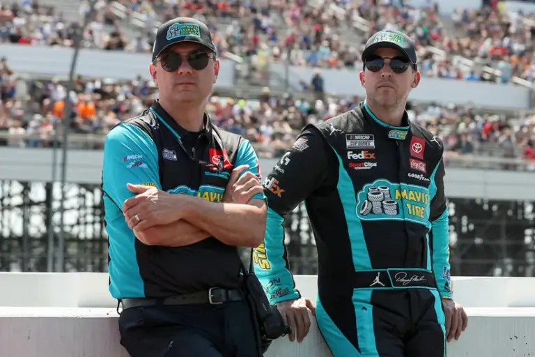 Spire; Jul 14, 2024; Long Pond, Pennsylvania, USA; NASCAR Cup Series driver Denny Hamlin (right) stands with his crew chief Chris Gabehart (left) on pit road prior to The Great American Getaway 400 at Pocono Raceway.
