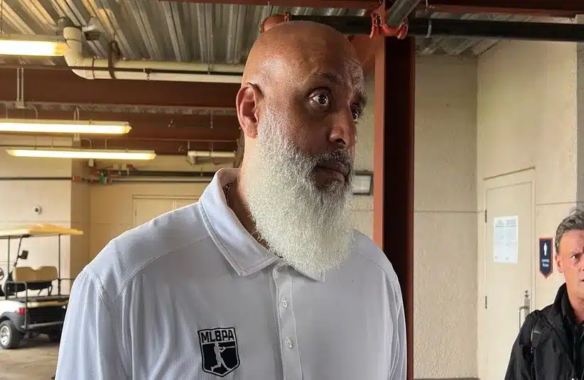 Major League Baseball Players Association executive director Tony Clark talks to reporters