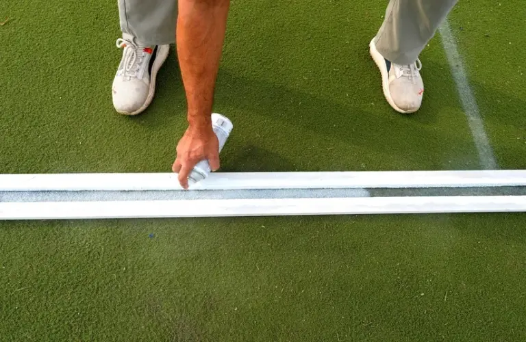 Cricket crease lines are spray painted on the pitch before the Pakistan Cricket Association 2025 T20 grand final.