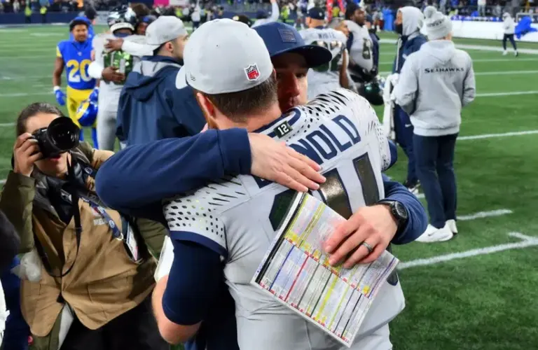 Seattle Seahawks quarterback Sam Darnold (14) hugs offensive coordinator Klint Kubiak after defeating the Los Angeles Rams
