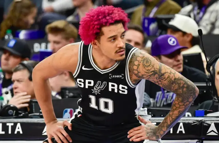 San Antonio Spurs forward Jeremy Sochan (10) stretches before substituting in during the second half against the Utah Jazz