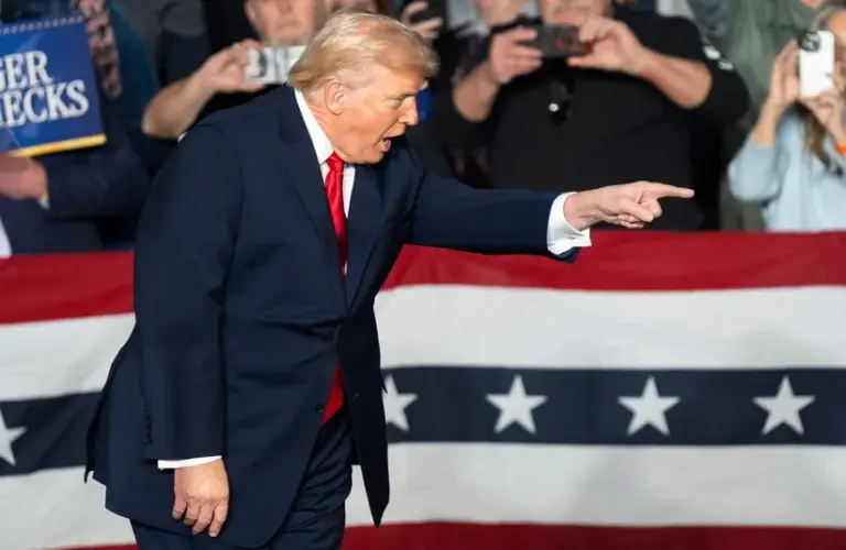 President Donald Trump points into the crowd during a rally
