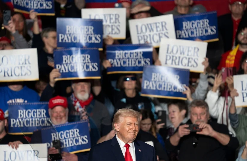 Trump smiling with fans behind