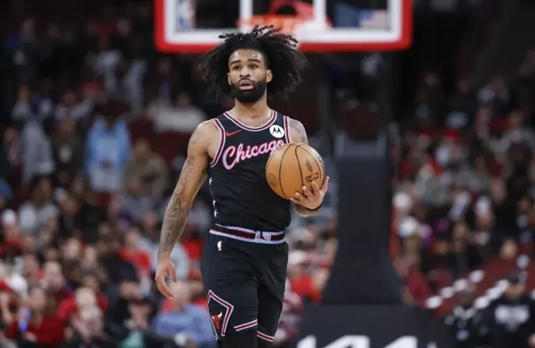 Chicago Bulls guard Coby White (0) brings the ball up court against the Miami Heat