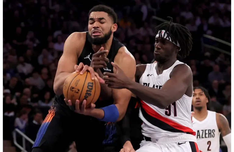 Karl Anthony Towns grabbing a rebound against the Portland Trail Blazers