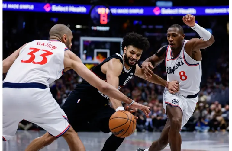Denver Nugget and New NBA All-Star Jamal Murray dribbling in between defenders vs Clippers
