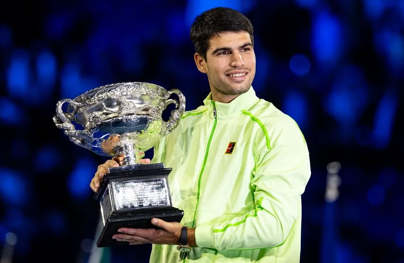 Carlos Alcaraz of Spain with the Norman Brookes Challenge Cup after his victory over Novak Djokovic of Serbia in the final of the menรญs singles at the Australian Open at Rod Laver Arena in Melbourne Park.