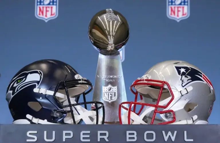 The Seattle Seahawks and New England Patriots helmets are displayed with the Vince Lombardi Trophy ahead of Super Bowl LX.
