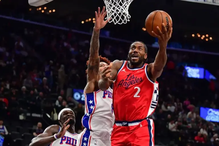 Feb 2, 2026; Inglewood, California, USA; Los Angeles Clippers forward Kawhi Leonard (2) moves to the basket ahead of Philadelphia 76ers guard Kelly Oubre Jr. (9) during the first half at Intuit Dome