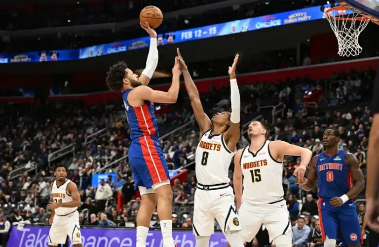 Detroit Pistons guard Cade Cunningham (2) shoots the ball over Denver Nuggets guard Peyton Watson (8) in the first quarter.