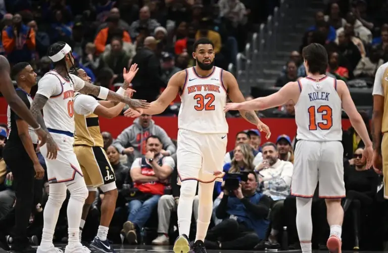 New York Knicks center Karl-Anthony Towns (32) celebrates a play with guard Jordan Clarkson (00) and guard Tyler Kolek (13) against the Washington Wizards