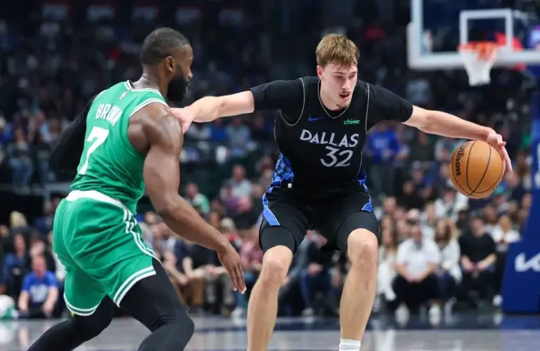 Dallas Mavericks forward Cooper Flagg (32) controls the ball as Boston Celtics guard Jaylen Brown (7)