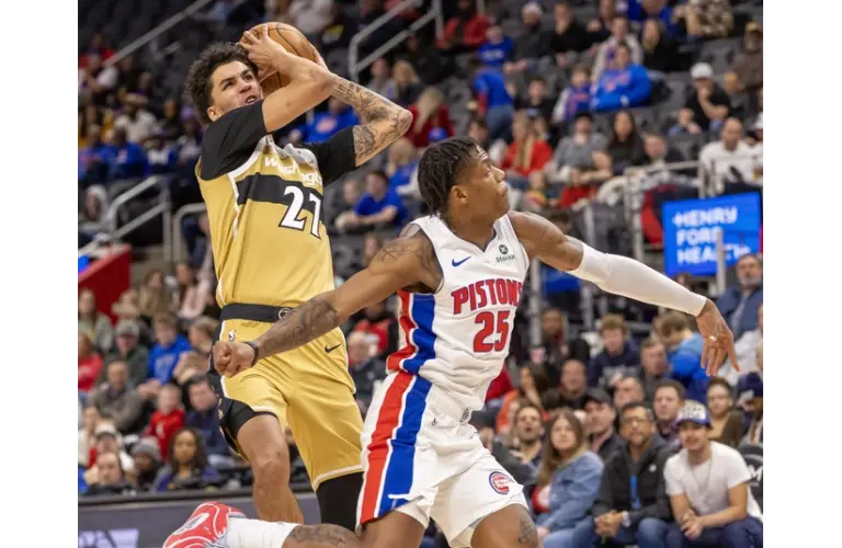 Wizards guard Will Riley drives hard to the net