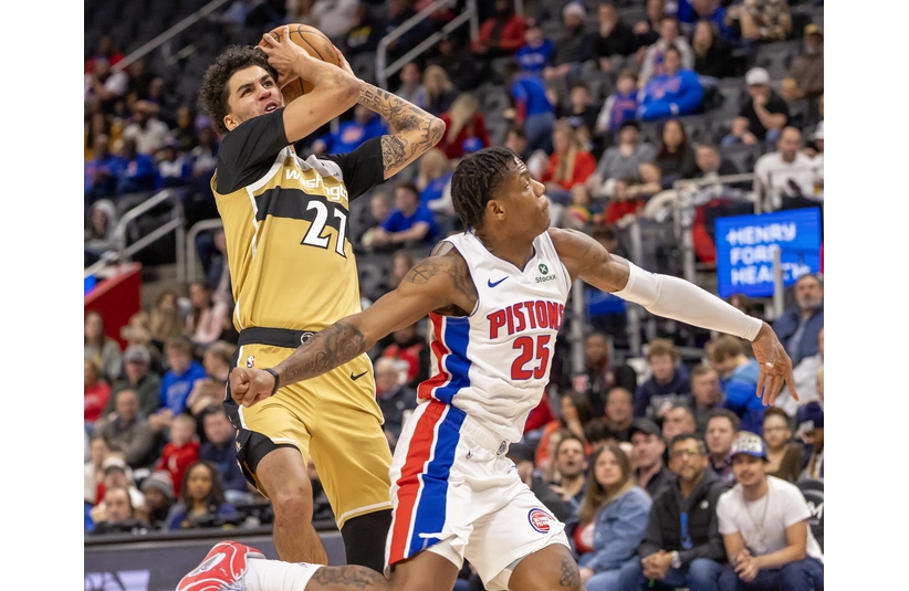 Wizards guard Will Riley drives hard to the net