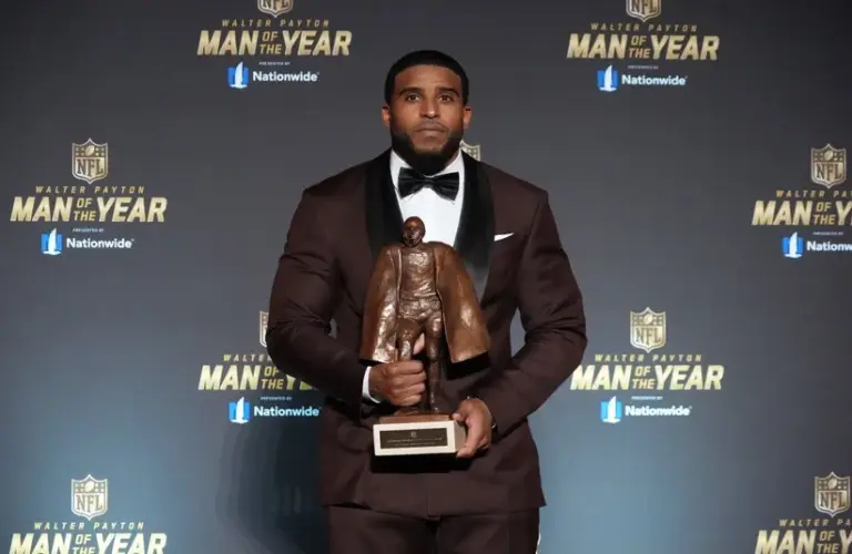 Washington Commanders linebacker Bobby Wagner poses with the Walter Payton Man of the Year award
